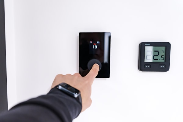 Hand adjusting a smart thermostat for home automation